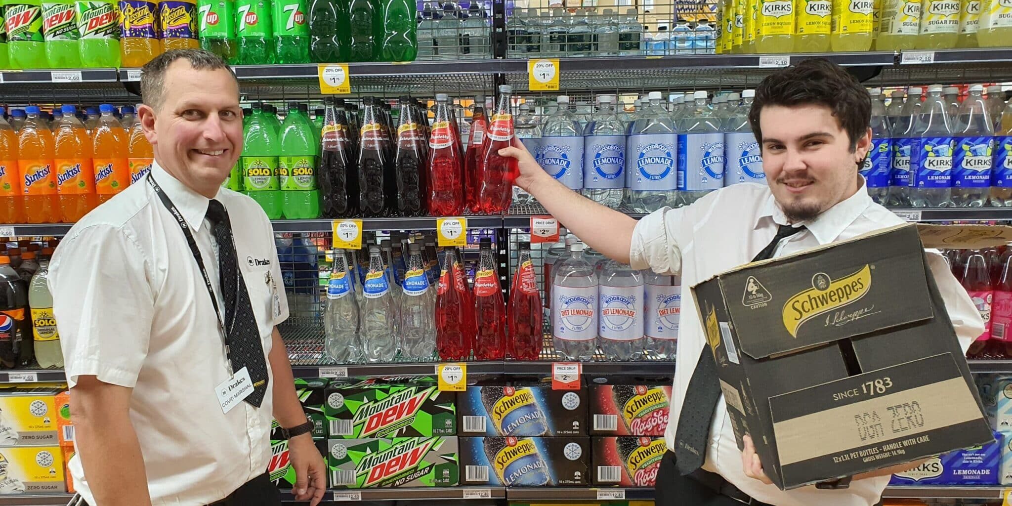 Two gentlemen stack shelves at Murray Bridge Drakes Supermarket