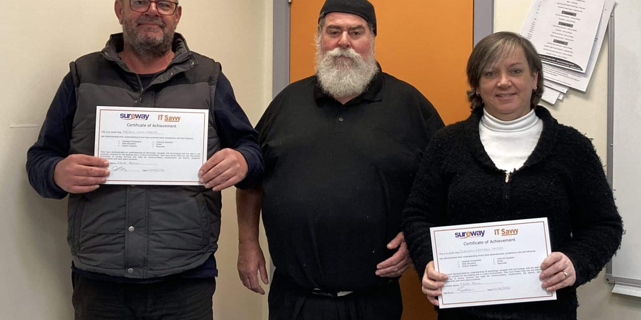 Three people smiling with certificates after completing the course